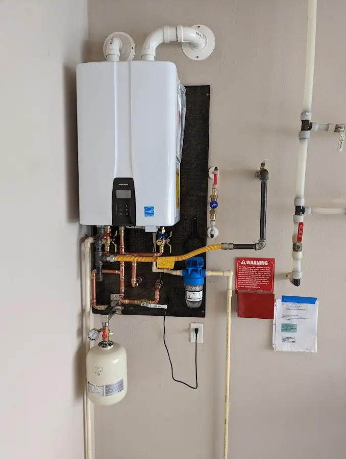 Professional plumber installing copper piping in a Grafton home